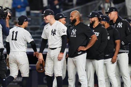 New York Yankees second baseman Anthony Volpe (11) reacts with designated hitter Ben Rice and teammates following Game 1 of baseball's American League Wild Card Series against the Boston Red Sox, Tuesday, Sept. 29, 2026, in New York. (AP Photo/Frank Franklin II) (AP Photo/Frank Franklin II)