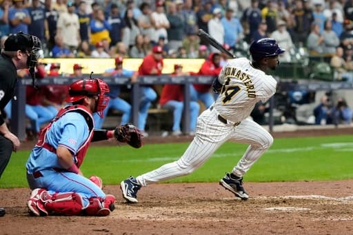 Playoff-bound Brewers rally from 5 runs down to beat skidding Cardinals 9-8 in 10 innings