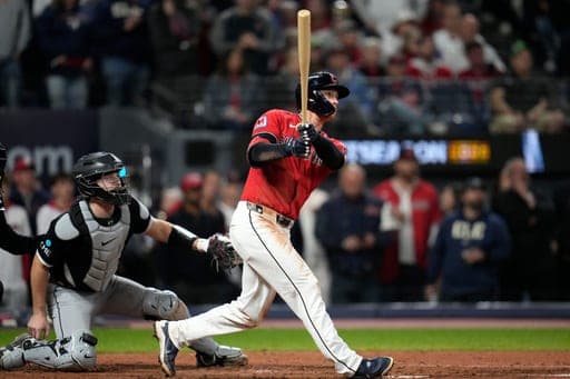 Cleveland Guardians center fielder Petey Halpin hits a double in the eighth inning of Game 5 of baseball's American League Division Series against the Chicago White Sox, Saturday, Oct. 10, 2026, in Cleveland. (AP Photo/Sue Ogrocki) (AP Photo/Sue Ogrocki)