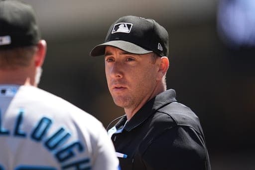 FILE - Miami Marlins manager Clayton McCullough (86), left, talks with home plate umpire Tom Hanahan during the second inning of a baseball game against the Minnesota Twins, Thursday, May 14, 2026, in Minneapolis. (AP Photo/Abbie Parr, File) (AP Photo/Abbie Parr)