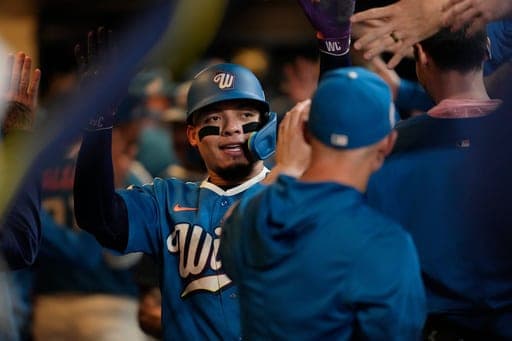 Milwaukee Brewers' William Contreras is congratulated in the dugout after hitting a three-run home run during the eighth inning of a baseball game against the Cincinnati Reds, Friday, Sept. 11, 2026, in Milwaukee. (AP Photo/Aaron Gash) (AP Photo/Aaron Gash)