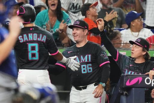 Miami Marlins' Javier Sanoja (8) is congratulated by manager Clayton McCullough (86) after scoring on a RBI double hit by Agustín Ramírez during the sixth inning of a baseball game against the Los Angeles Dodgers, Friday, Sept. 11, 2026, in Miami. (AP Photo/Lynne Sladky) (AP Photo/Lynne Sladky)