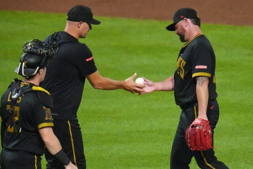 Pittsburgh Pirates pitcher Kirby Yates, right, hands the ball to manager Don Kelly during the ninth inning of a baseball game against the Boston Red Sox in Pittsburgh, Friday, Aug. 14, 2026. (AP Photo/Gene J. Puskar) (AP Photo/Gene J. Puskar)