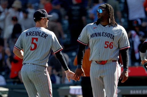 Minnesota Twins' Josh Bell (56) and Ryan Kreidler (5) celebrate their team's victory against the San Francisco Giants during a baseball game in San Francisco, Wednesday, Sept. 23, 2026. (AP Photo/Jed Jacobsohn) (AP Photo/Jed Jacobsohn)