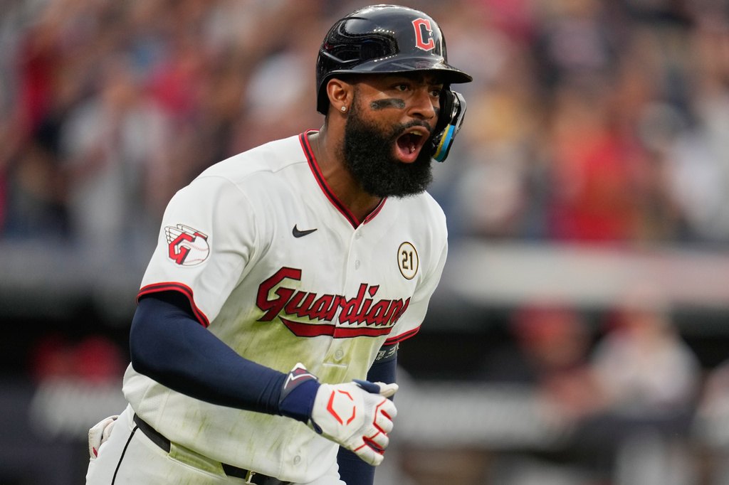 Guardians outfielder Jo Adell shouts as he rounds the bases after a home run against the White Sox.