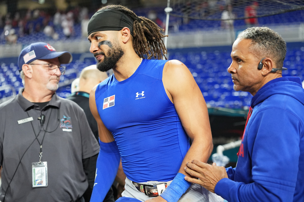 Fernando Tatis Jr. walks alongside his father, former big leaguer Fernando Tatis Sr., after a 2026 World Baseball Classic game in Miami.