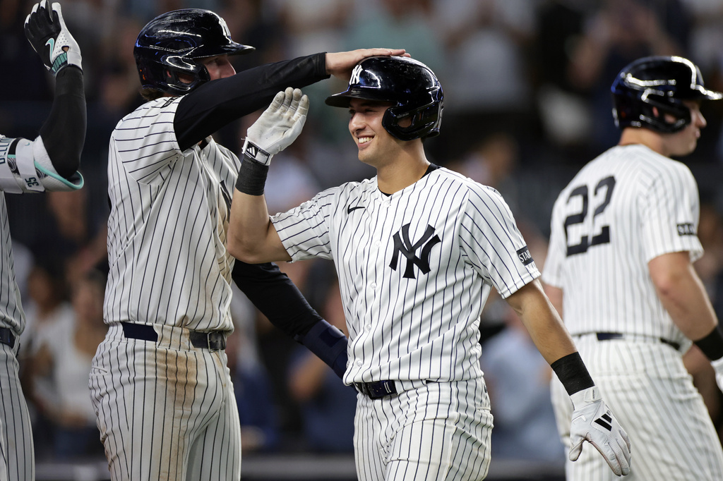 Yankees infielder Anthony Volpe is congratulated by teammates after a grand slam.