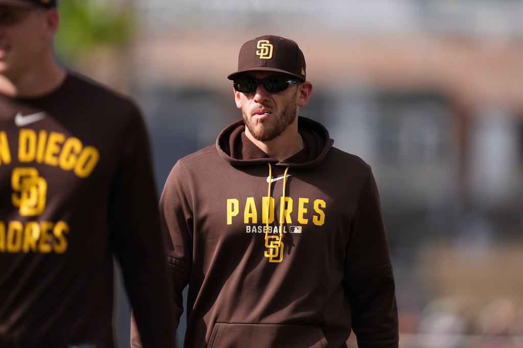 Padres pitcher Joe Musgrove walks with teammates before a game.
