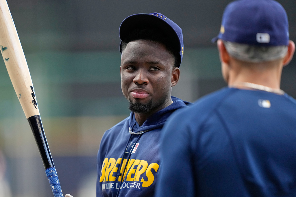 Brewers teammates Luis Lara and Joey Ortiz talk before Game 1 of the National League Division Series.