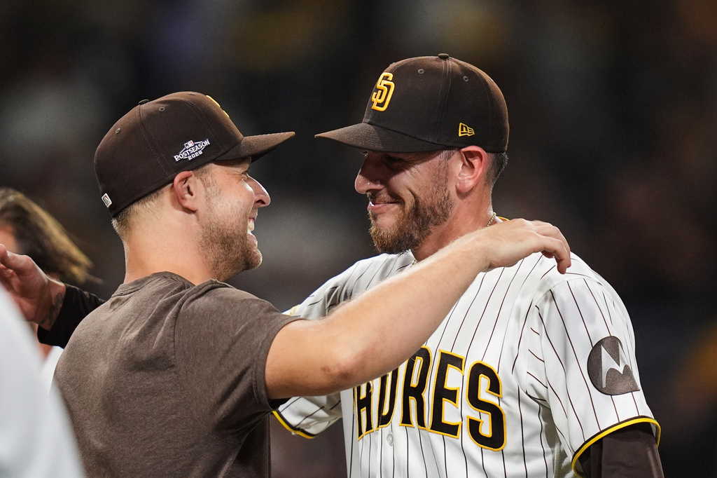 Padres pitchers Joe Musgrove and Michael King greet catcher Luis Campusano after a Wild Card Series win.