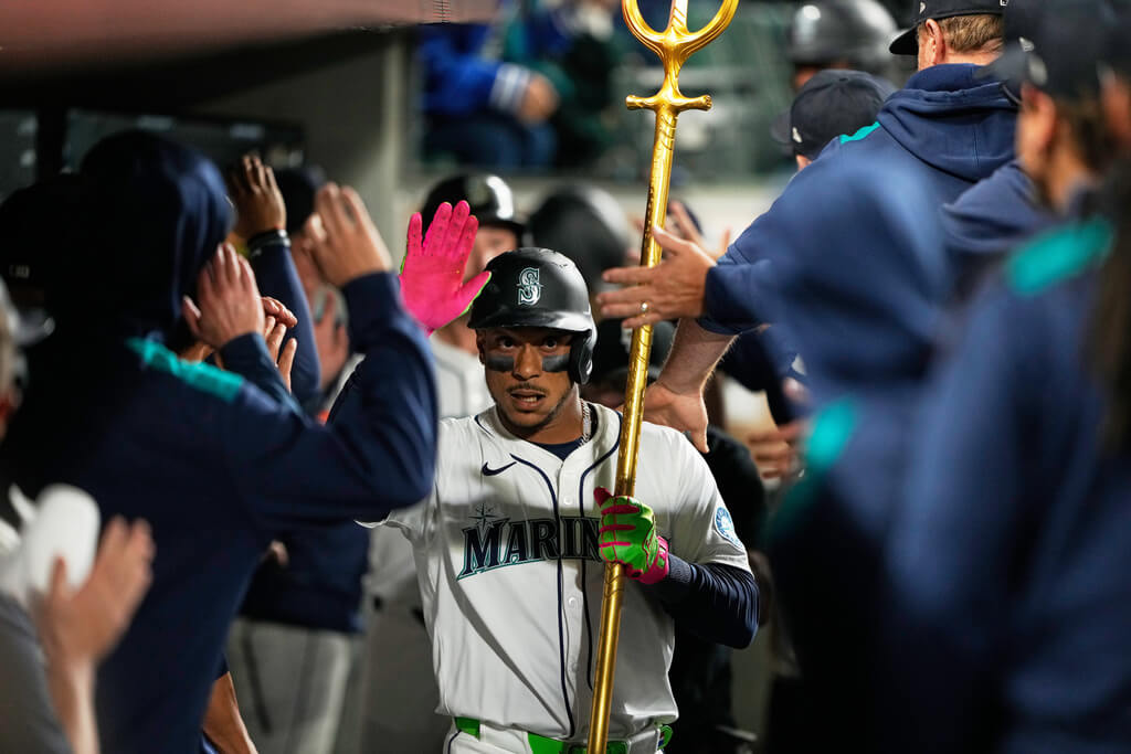 Title: Dodgers Mariners BaseballImage ID: 25271121333929 Article: Seattle Mariners' Jorge Polanco celebrates in the dugout after hitting a go-ahead three-run home run that also scored Cal Raleigh and Julio Rodriguez during the fifth inning of a baseball game against the Los Angeles Dodgers, Saturday, Sept. 27, 2025, in Seattle. (AP Photo/Ryan Sun) 