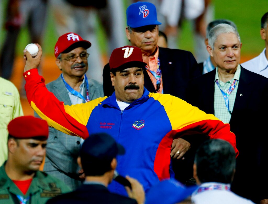 Venezuela's President Nicolas Maduro throws the ball during the opening ceremony of the Caribbean Series baseball tournament in Porlamar, Venezuela, Saturday, Feb. 1, 2014