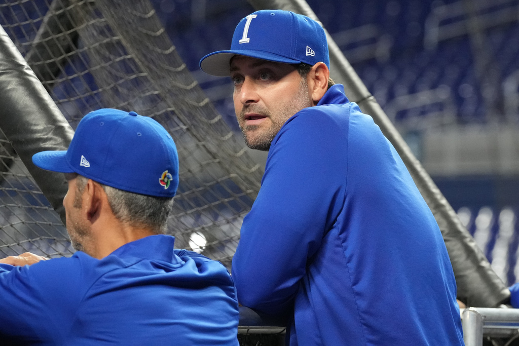 Italy manager Francisco Cervelli high-fives his players before a World Baseball Classic quarterfinal.