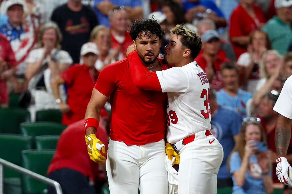 Bryan Torres congratulates Ivan Herrera after his walk-off double