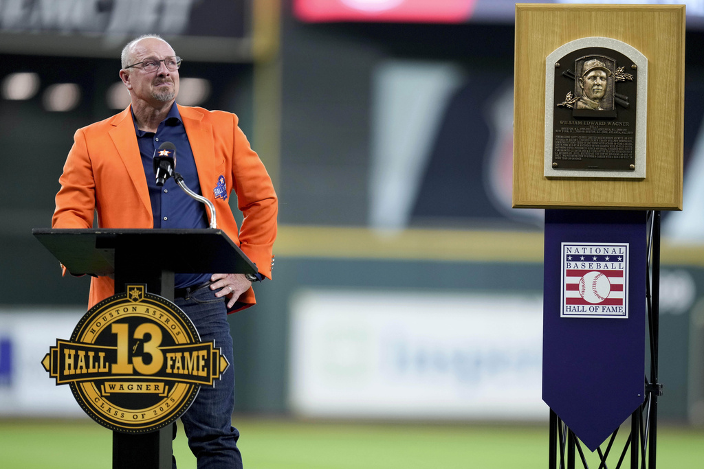 Hall of Famer Billy Wagner speaks at his Astros number retirement ceremony in Houston in August 2025, beside his Cooperstown plaque.