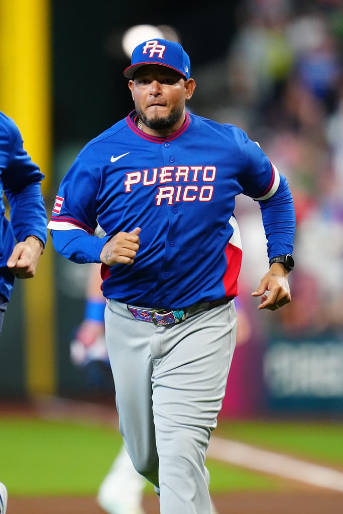Title: WBC Puerto Rico Italy Baseball Image ID: 26073714390605 Article: Puerto Rico manager Yadier Molina jogs back to the dugout after checking on a player during the second inning of a World Baseball Classic quarterfinal game against Italy, Saturday, March 14, 2026, in Houston. (AP Photo/Karen Warren)