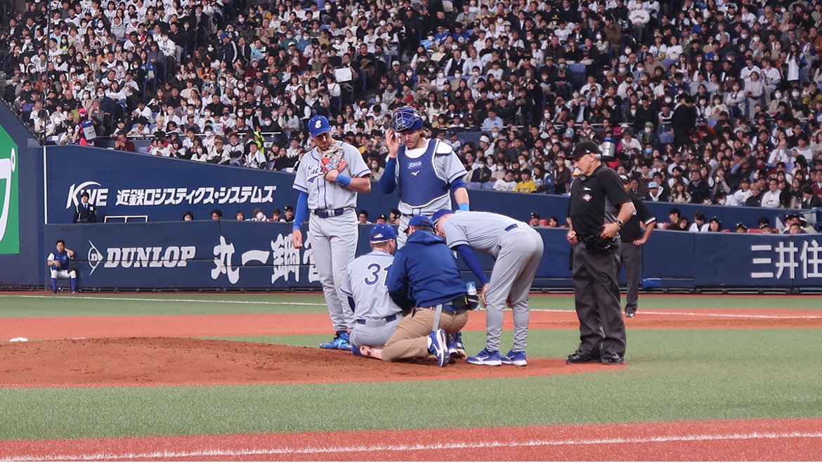 Members of the Team All-Europe staff check on pitcher Martin Schneider, who dislocated his shoulder throwing a pitch to Japan’s Kensuke Kondoh in game one of the 2024 CARNEXT Samurai Japan Series at the Kyocera Dome in Osaka, Japan. (Photo: Dante Angiotti/Federazione Italiana Baseball Softball)