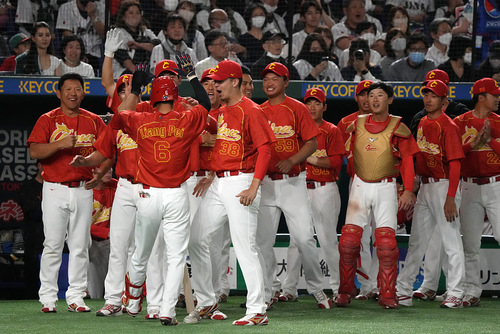 China Liang Pei rounds the bases after hitting a home run in the World Baseball Classic, celebrating a key moment for the national team. (CGTN)