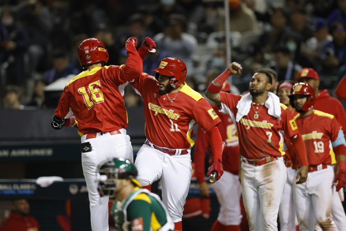 Team Spain players celebrate at home plate after scoring a run in their 9-1 victory over South Africa in the 2025 World Baseball Classic Qualifiers.