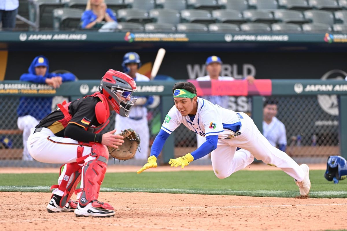 Daniel Yonemura of Team Brazil slides into home plate against Germany at the 2025 WBC Qualifier in Tucson, securing a run in the eighth inning.