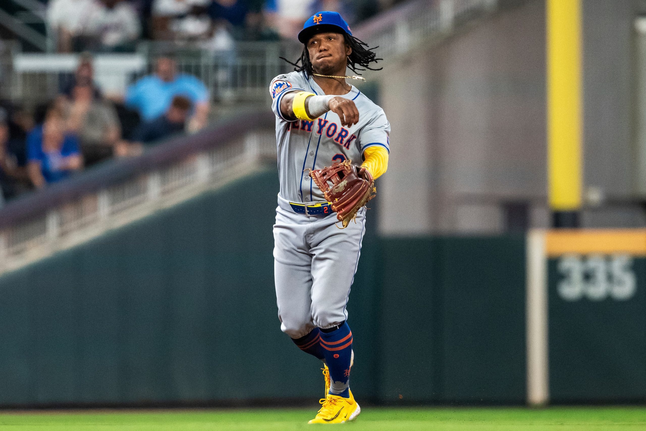 Luisangel Acuna throws to first base during a Mets vs Braves game in 2024