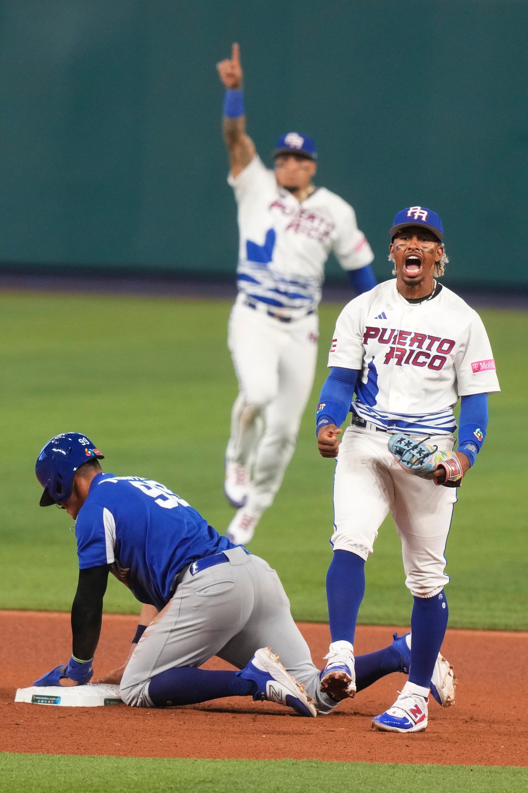 Puerto Rico infielder Francisco Lindor, right, yells after tagging out Nicaragua's stolen base attempt in the 2023 World Baseball Classic