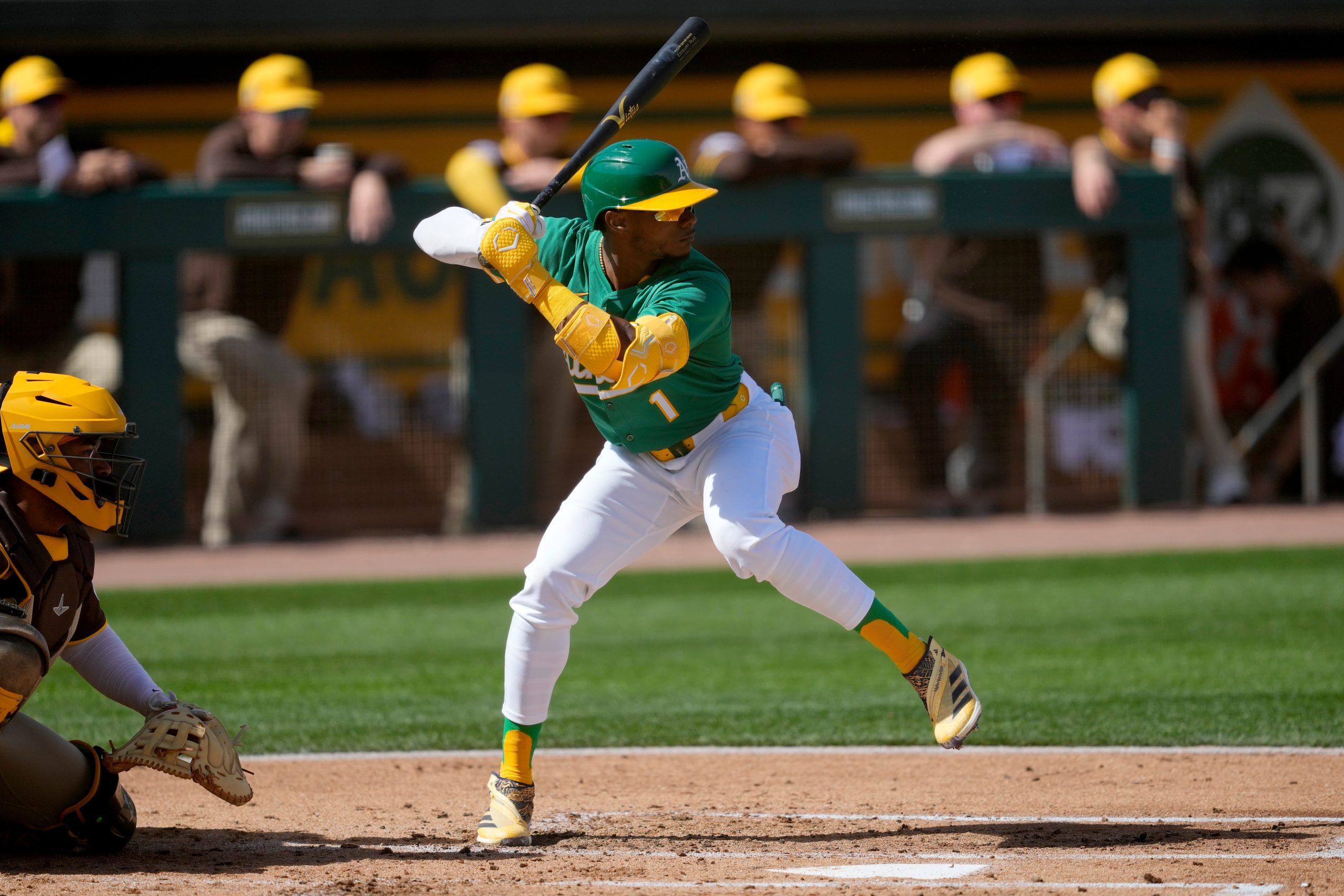 Dominican outfielder Esteury Ruiz warms up before a 2024 game with the Athletics, wearing a green jersey and white pants.
