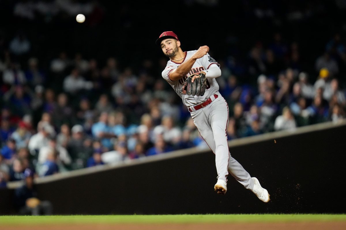 Arizona Diamondbacks shortstop Jordan Lawlar throws to first for the out on Chicago Cubs' Mike Tauchman during the fifth inning of a baseball game