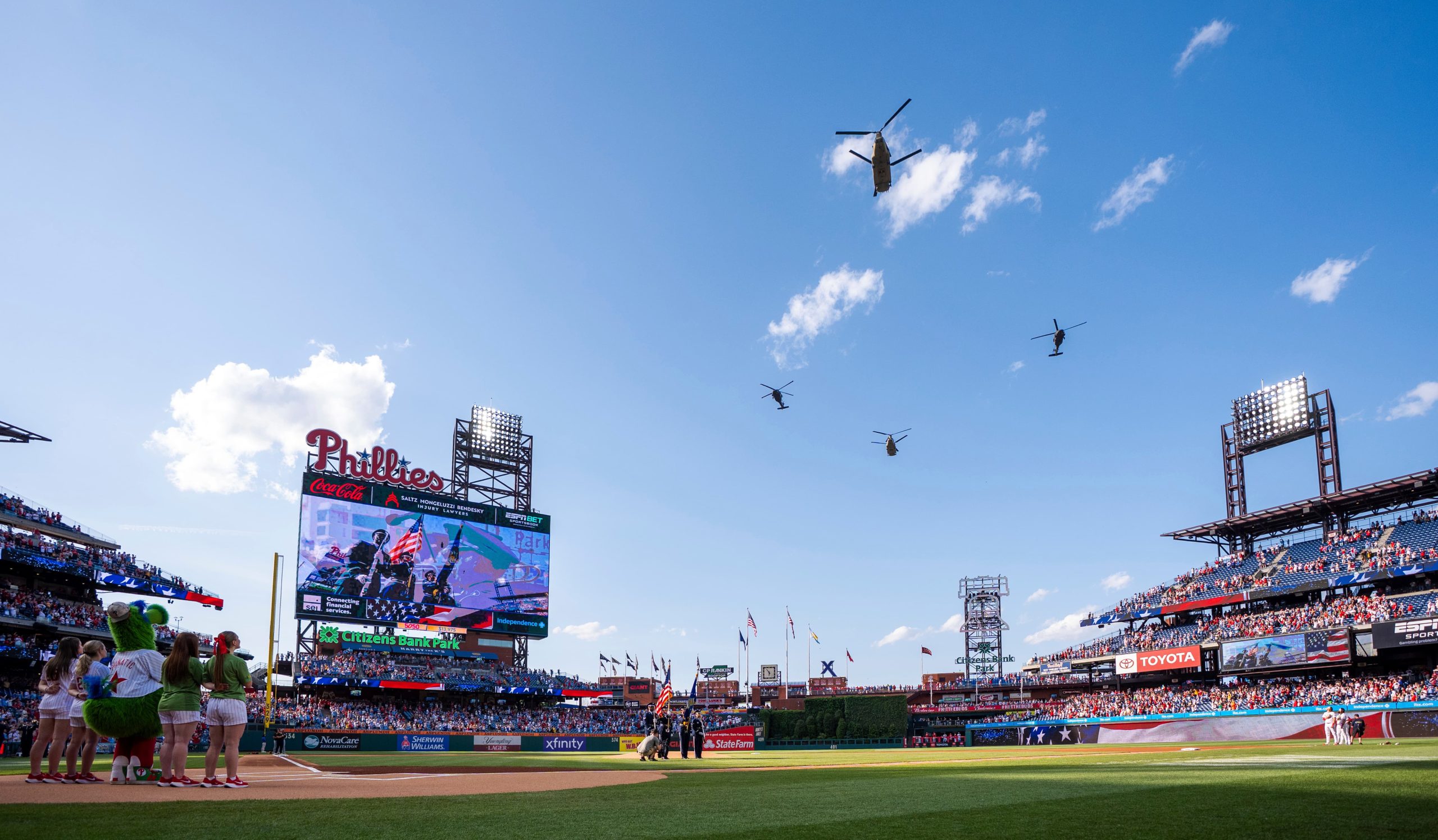 Blackhawk and Chinook helicopters perform a flyover during the national anthem prior to a baseball game between the Pittsburgh Pirates and the Philadelphia Phillies, Saturday, May 17, 2025, in Philadelphia.