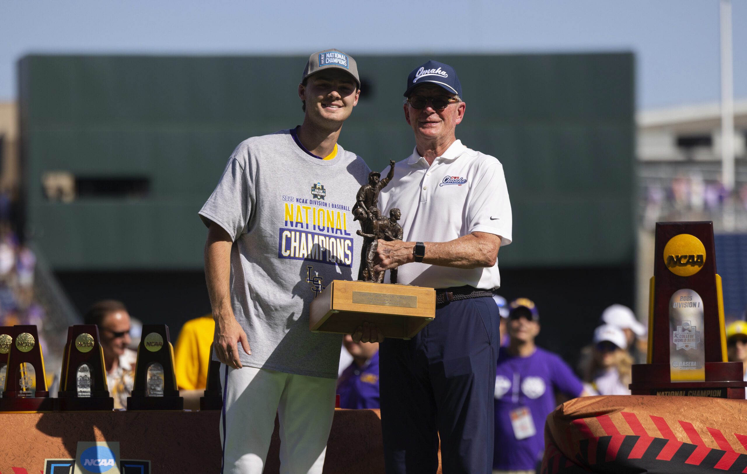 Jack Diesing, Jr., right, presents the John Diesing, Sr., Most Outstanding Player award to LSU pitcher Kade Anderson following their win against Coastal Carolina in Game 2 of the NCAA College World Series baseball finals in Omaha, Neb., Sunday, June 22, 2025.