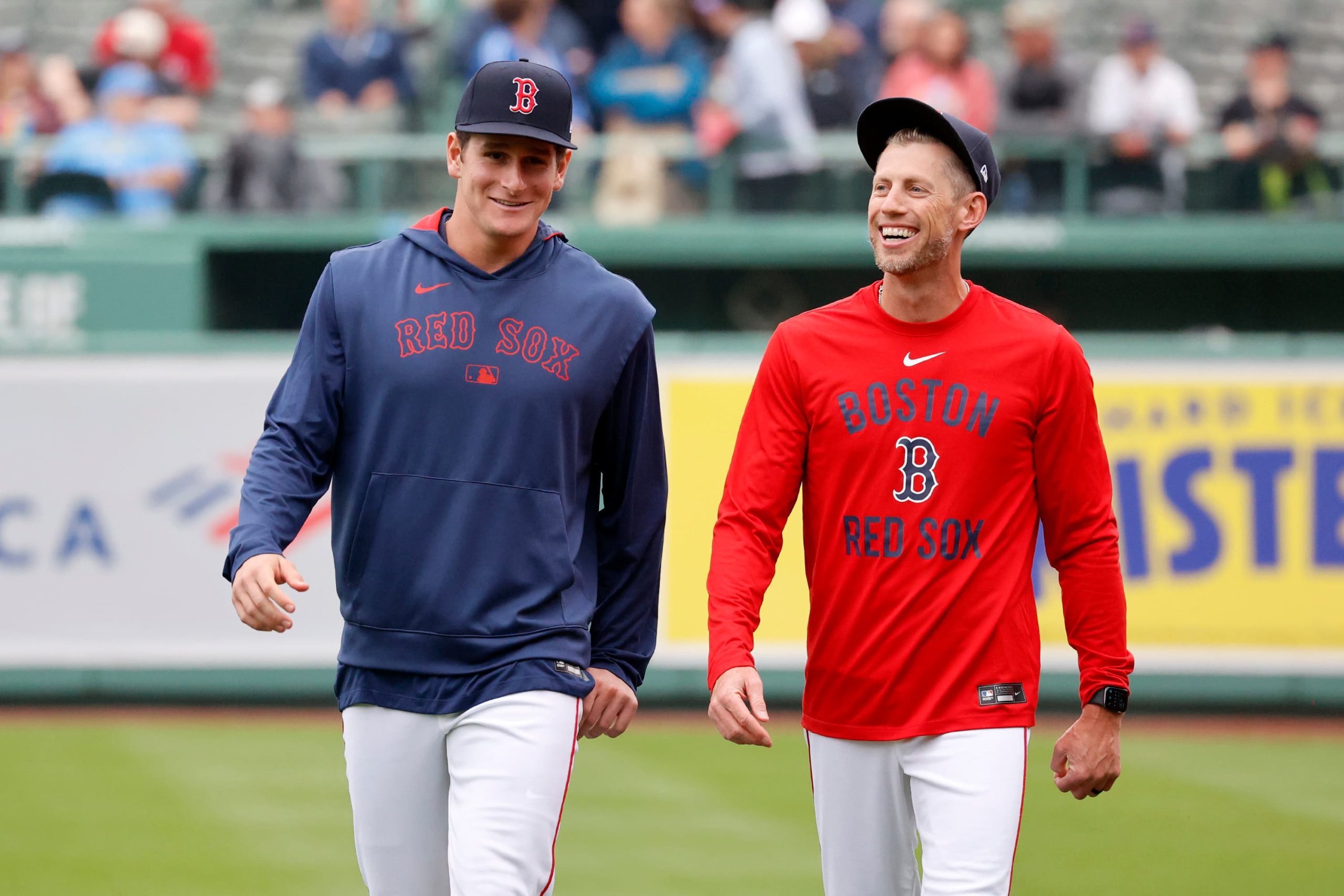 Boston Red Sox outfielder Roman Anthony, left, smiles as he walks with third base coach Kyle Hudson before making his first major league start in a baseball game against the Tampa Bay Rays at Fenway Park, Monday, June 9, 2025, in Boston.