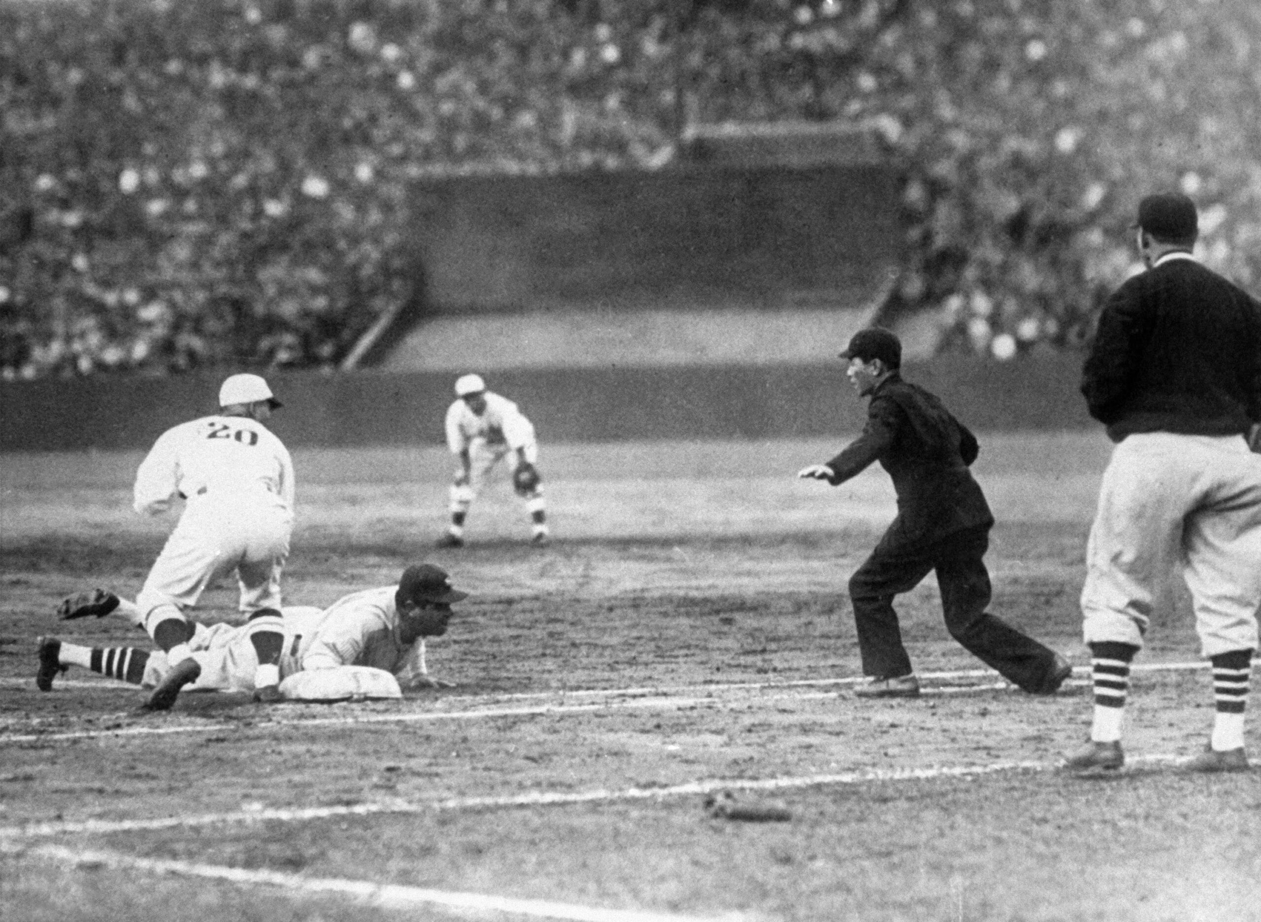 Title: Babe Ruth 1934 Image ID: 341121011 Article: A Japanese pitcher tries to catch Babe Ruth off first base but the empire calls Ruth safe, Nov. 21, 1934, during an exhibition game in Meiji Stadium, Tokyo. (AP Photo)