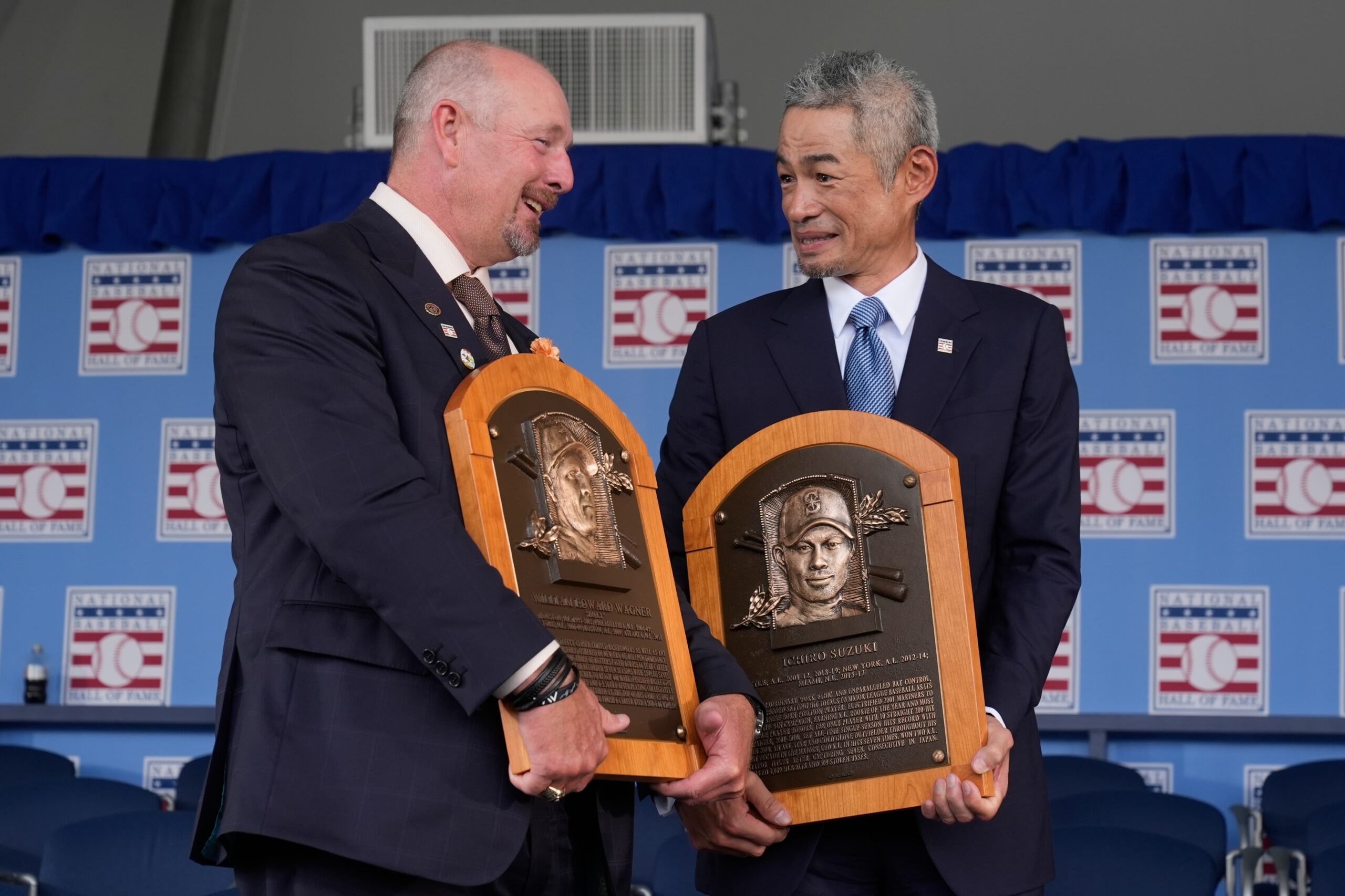 Baseball Hall of Fame inductees Billy Wagner, left, and Ichiro Suzuki, right, talk while gathering for a photo at the National Baseball Hall of Fame induction ceremony in Cooperstown, N.Y., Sunday, July 27, 2025
