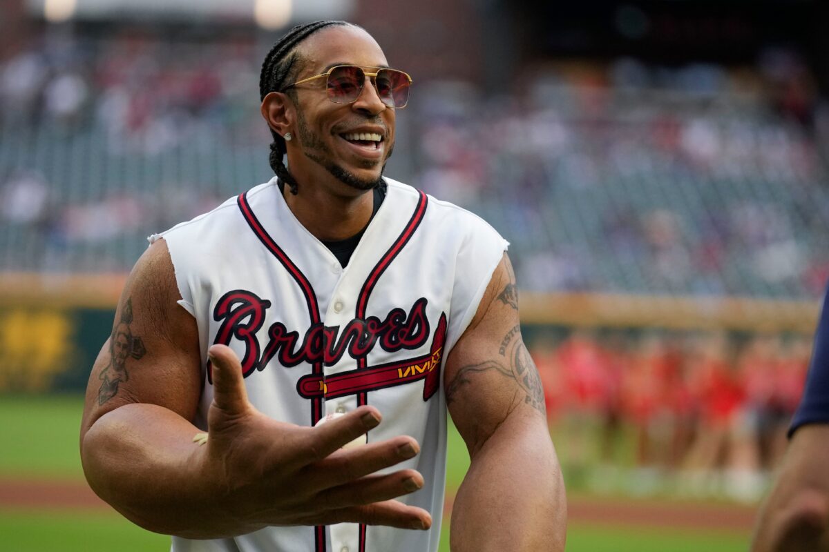 Ludacris poses after he throws out the ceremonial first pitch