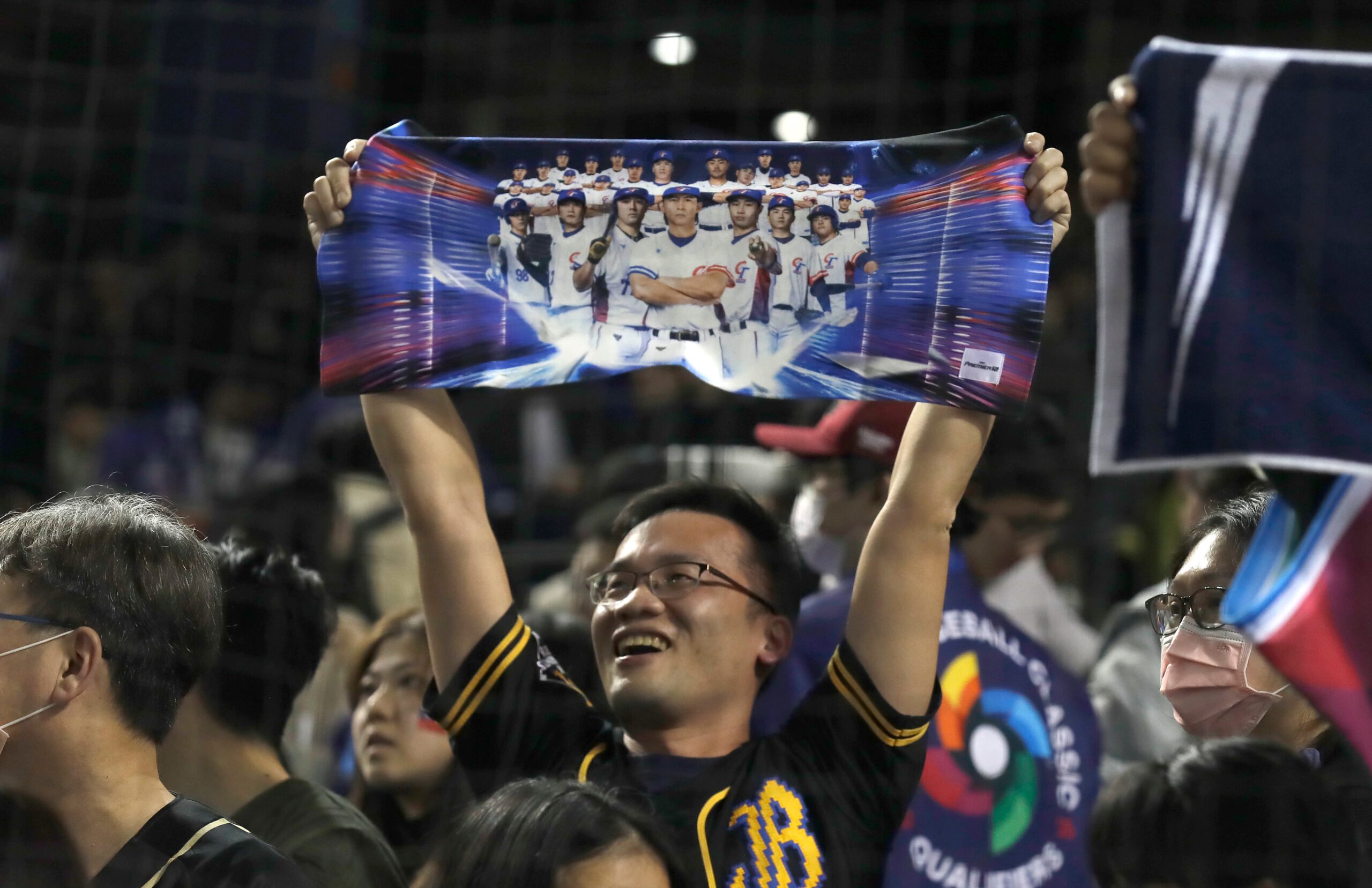 Title: WBC Taiwan Spain Baseball Image ID: 25056532051756 Article: Fans celebrate after winning the World Baseball Classic qualifying game between Taiwan win Spain in Taipei, Taiwan, Tuesday, Feb. 25, 2025. (AP Photo/Chiang Ying-ying)