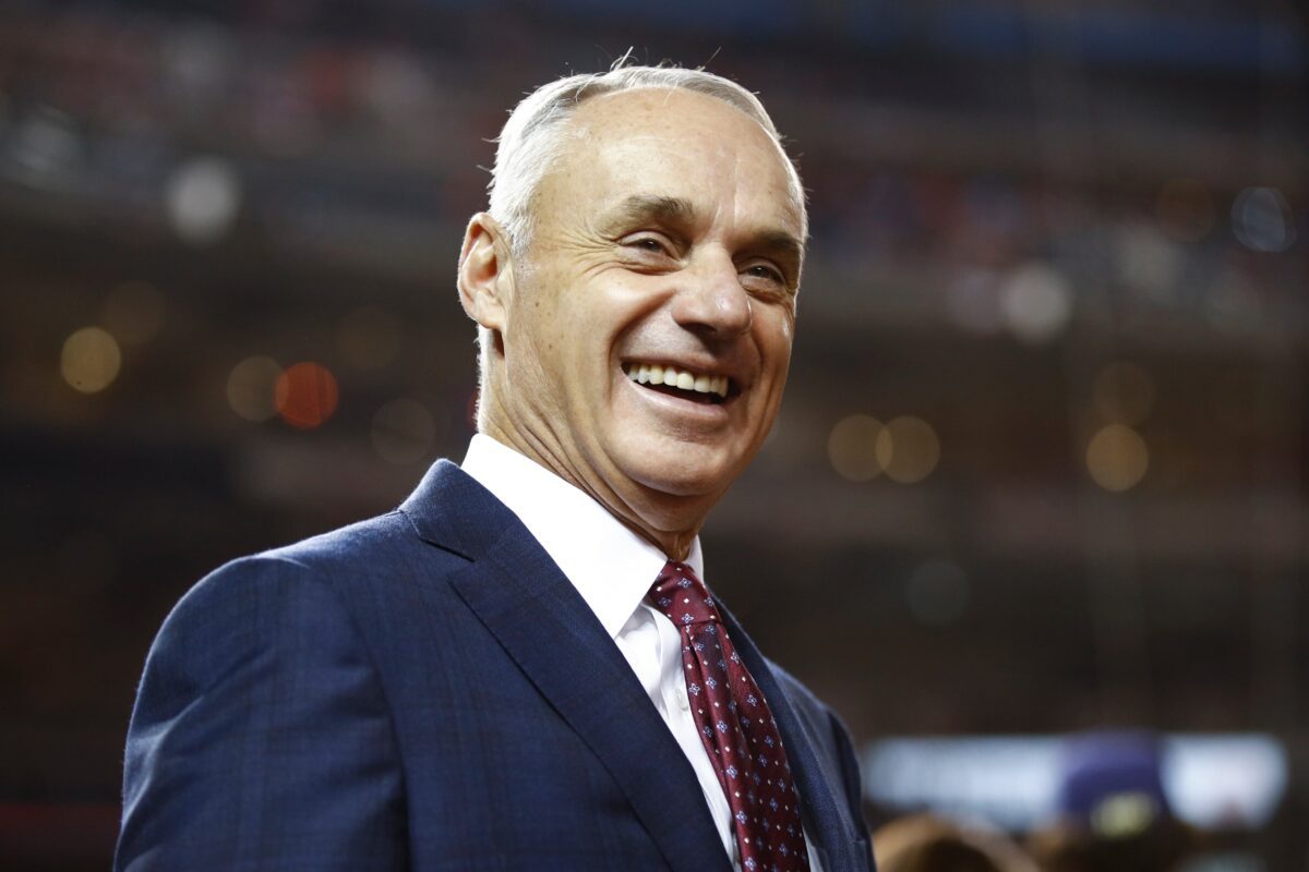 Title: World Series Astros Nationals Baseball Image ID: 19299819653325 Article: MLB commissioner Rob Manfred smiles at batting practice before Game 4 of the baseball World Series between the Houston Astros and the Washington Nationals Saturday, Oct. 26, 2019, in Washington. (AP Photo/Patrick Semansky)