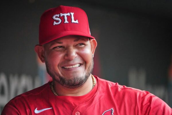 t. Louis Cardinals guest coach Yadier Molina is seen in the dugout before the start of a baseball game against the Chicago Cubs Friday, Aug. 8, 2025, in St. Louis