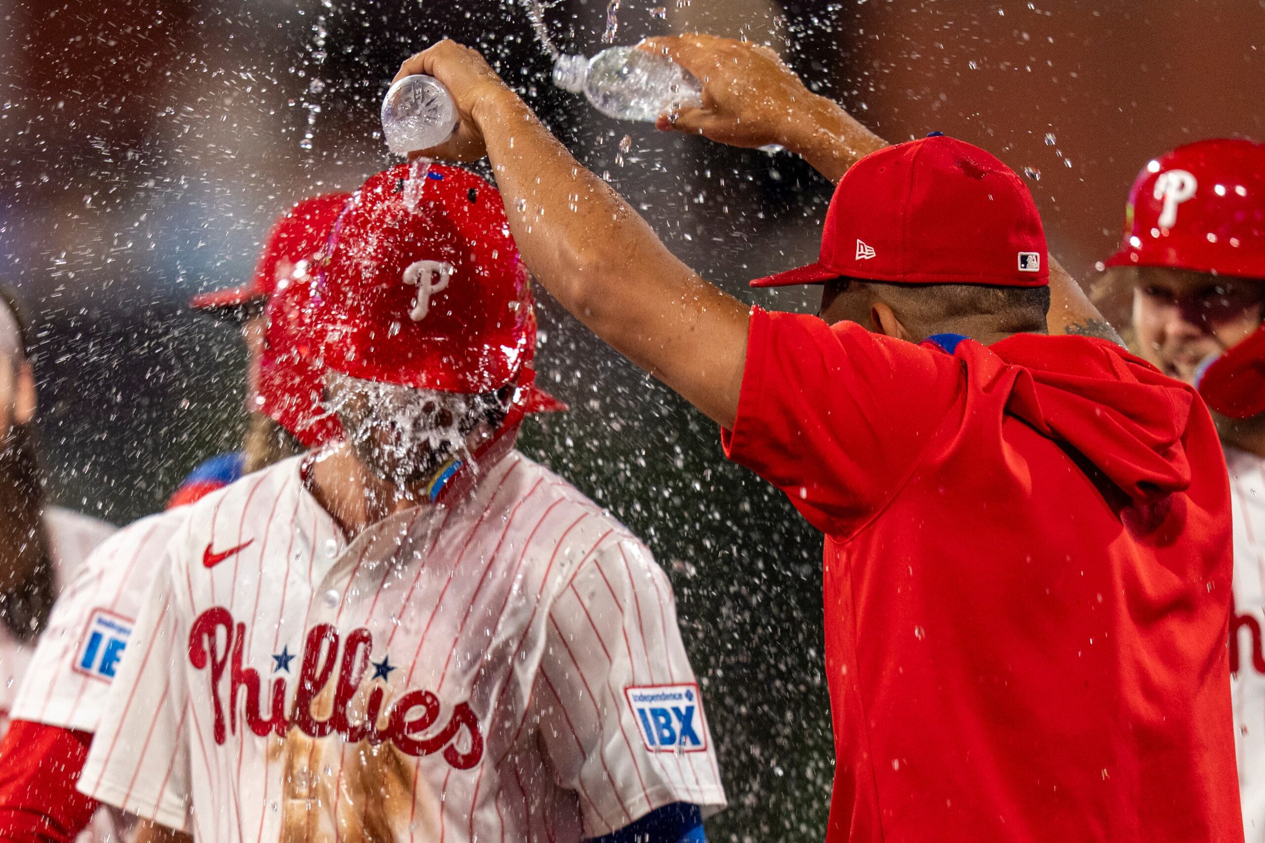 Title: APTOPIX Braves Phillies Baseball Image ID: 25243045475507 Article: Philadelphia Phillies' Trea Turner, left, gets doused by a teammates after hitting the game-winning single following the 10th inning of a baseball game against the Atlanta Braves, Saturday, Aug. 30, 2025, in Philadelphia. (AP Photo/Chris Szagola)