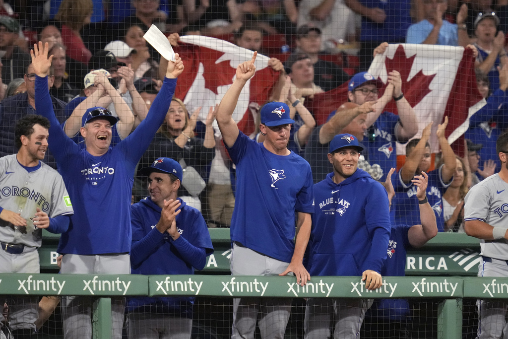 Title: Blue Jays Red Sox BaseballImage ID: 24240019664623 Article: Toronto Blue Jays players and fans celebrate after a three-run home run by George Springer against the Boston Red Sox during the fifth inning of a baseball game at Fenway Park, Monday, Aug. 26, 2024, in Boston. (AP Photo/Charles Krupa) 
