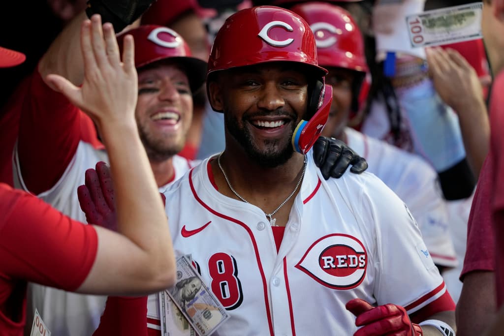 Title: Phillies Reds BaseballImage ID: 25226011698380
Article:  Cincinnati Reds' Miguel Andujar celebrates in the dugout after hitting a grand slam home run during the seventh inning of a baseball game against the Philadelphia Phillies Wednesday, Aug. 13, 2025, in Cincinnati. (AP Photo/Carolyn Kaster)
