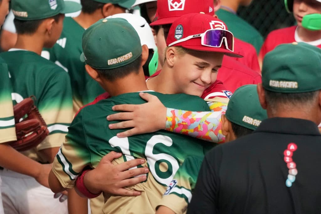 Title: APTOPIX LLWS Nevada Taiwan Baseball Image ID: 25236768314297 Article: Taiwan's Liu Wei-Heng, center left, gets a hug from Las Vegas, Nev.'s Garrett Gallegos, center right, in the handshake line following the Little League World Series Championship baseball game in South Williamsport, Pa., Sunday, Aug. 24, 2025. (AP Photo/Gene J. Puskar)