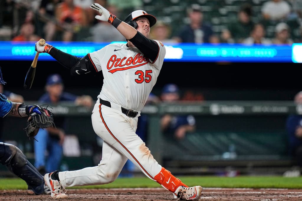 Bobblehead day for Baltimore Orioles' Adley Rutschman (35) hits an RBI double during the eighth inning in the second baseball game of a doubleheader against the Toronto Blue Jays, Tuesday, July 29, 2025, in Baltimore. (AP Photo/Stephanie Scarbrough)