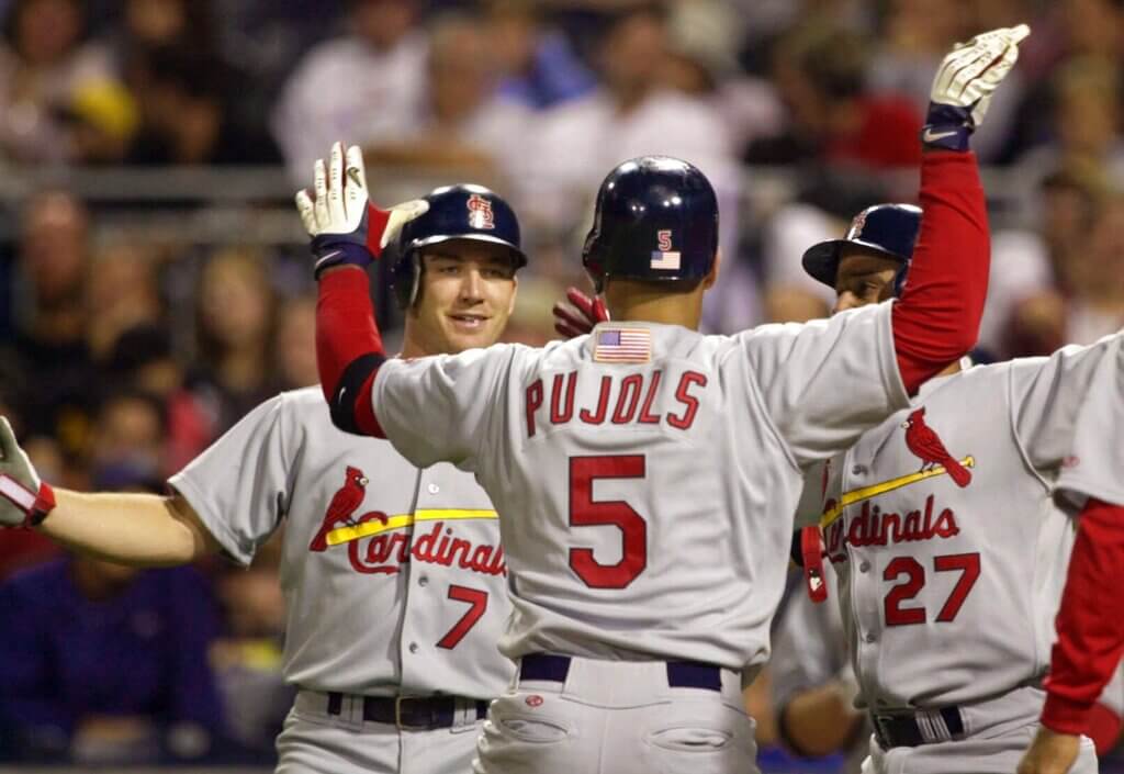 Albert Pujols and Plácido Polanco high-five as St. Louis Cardinals teammates during the 2001 season. (AP Photo)