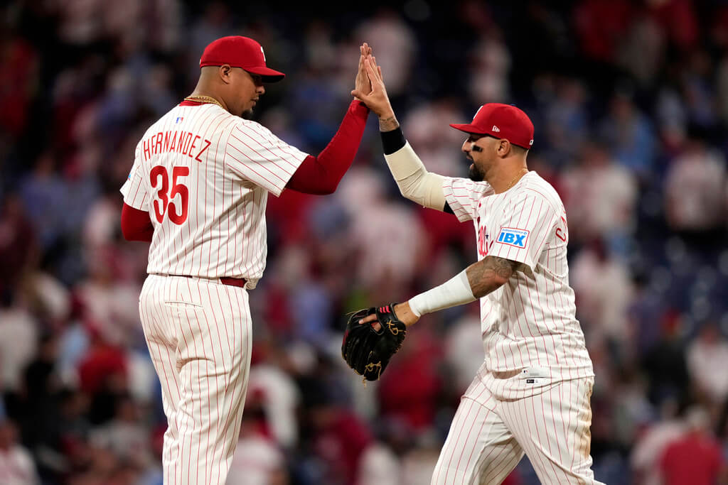 Philadelphia Phillies pitcher Carlos Hernández, left, and right fielder Nick Castellanos celebrate after the Phillies won a baseball game against the Washington Nationals, Wednesday, April 30, 2025, in Philadelphia. (AP Photo/Matt Slocum)