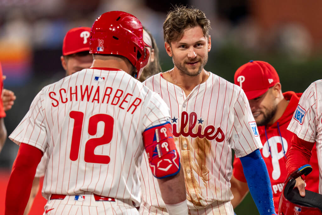 Philadelphia Phillies' Trea Turner, right, looks on as they celebrate his game-winning hit following the 10th inning of a baseball game against the Atlanta Braves, Saturday, Aug. 30, 2025, in Philadelphia. (AP Photo/Chris Szagola)