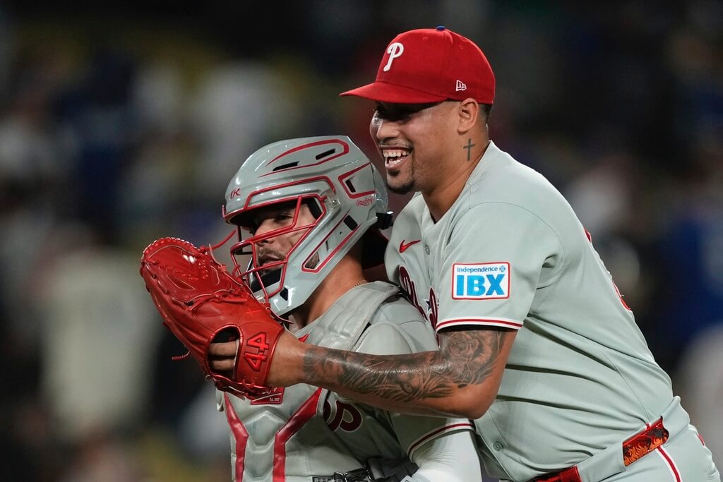 Philadelphia Phillies' relief pitcher Jhoan Duran, right, celebrates with catcher Rafael Marchan after the Phillies defeated the Los Angeles Dodgers in a baseball game Tuesday, Sept. 16, 2025, in Los Angeles. (AP Photo/Mark J. Terrill)