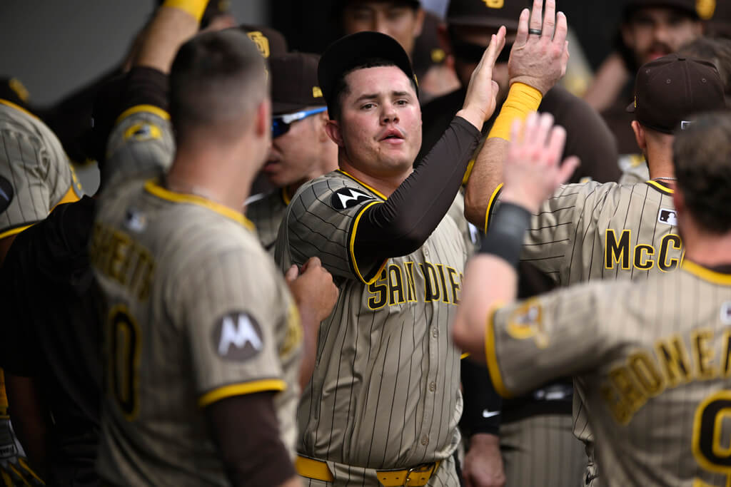 San Diego Padres relief pitcher Adrian Morejon, center, celebrates with teammates in the dugout during the sixth inning of an baseball game against the Chicago White Sox, Sunday, Sept. 21, 2025, in Chicago. (AP Photo/Paul Beaty)