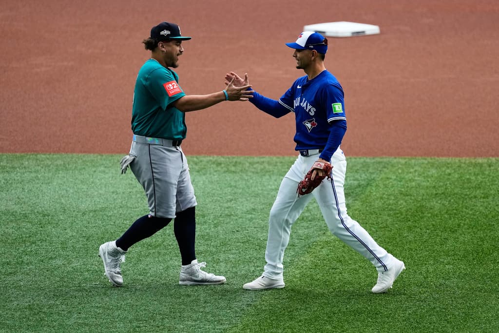 Title: ALCS Mariners Blue Jays BaseballImage ID: 25286757967384 Article: Seattle Mariners' Josh Naylor, left, greets Toronto Blue Jays' Andrés Giménez prior to Game 2 of baseball's American League Championship Series against the Toronto Blue Jays, Monday, Oct. 13, 2025, in Toronto. (AP Photo/David J. Phillip) 
