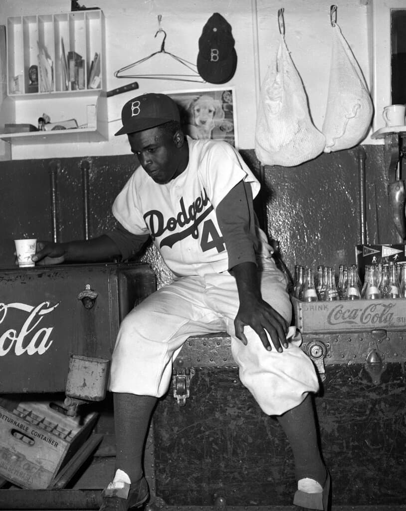 Title: JACKIE ROBINSON 1952Image ID: 5210070115 Article: Brooklyn Dodgers' second baseman Jackie Robinson sits dejectedly in the clubhouse at Ebbets Field in Brooklyn, N.Y., Oct. 7, 1952, following the Dodgers' loss to the Yankees in the finale of the 1952 World Series. The Dodgers have gone up against the Yanks in three World Series but have never defeated them. (AP Photo)