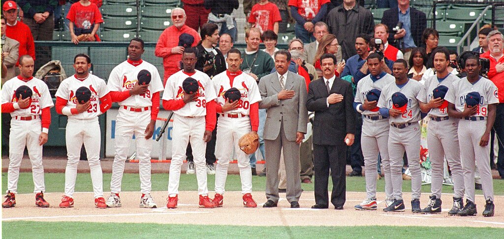 Dominican Republic players from the St. Louis Cardinals and Chicago Cubs stand for the national anthems alongside President Leonel Fernández and Juan Marichal at Busch Stadium, 1999.